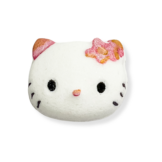 A bath bomb designed to look like a kitty face with a pink and white color scheme.