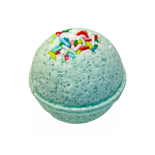 A green bath bomb with multicolored sprinkles on top, resembling a playful and festive treat.