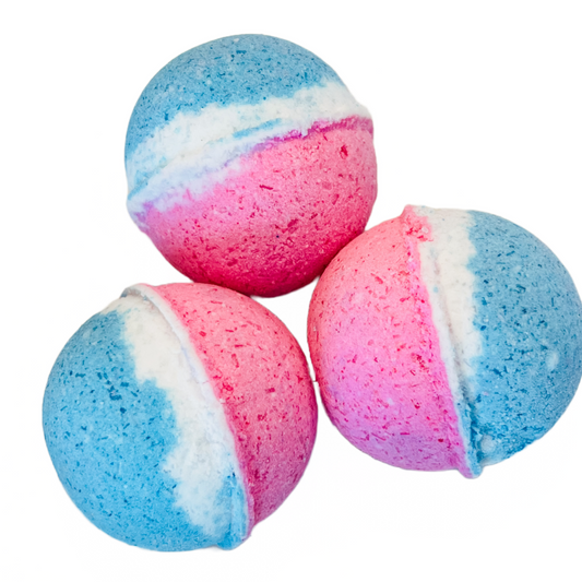 Three bath bombs with blue, pink, and white colors, resembling a rocket popsicle in terms of flavor and appearance.